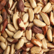 A pile of shelled Brazil nuts on a plain background.