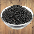 A bag of black sesame seeds, also known as Kaale Til.
