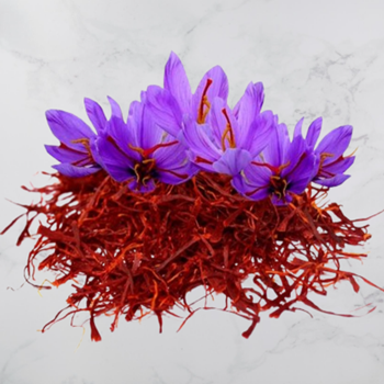 A container of Saffron (Kesar Kashmiri), a high-quality spice known for its vibrant color and rich aroma.